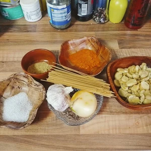 Küchenarbeitsplatte mit Schalen, in denen unterschiedliche Inhalte sich befinden. Salz, Paprikapulver, Pilze, Zwiebel, Knoblauch, Gemüsebrühe und Spaghetti